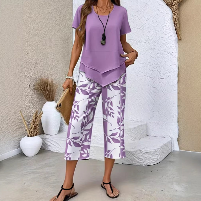 🥳2026 HOT SALE🥳💞50K+ SOLD!💕🌿 50% OFF! 2-Piece Tunic & Wide Leg Pants Set – No matching hassle, instantly chic. Layered asymmetrical top, leaf-print capri pants. Sizes S-5XL. Your new favourite. 👖✅
